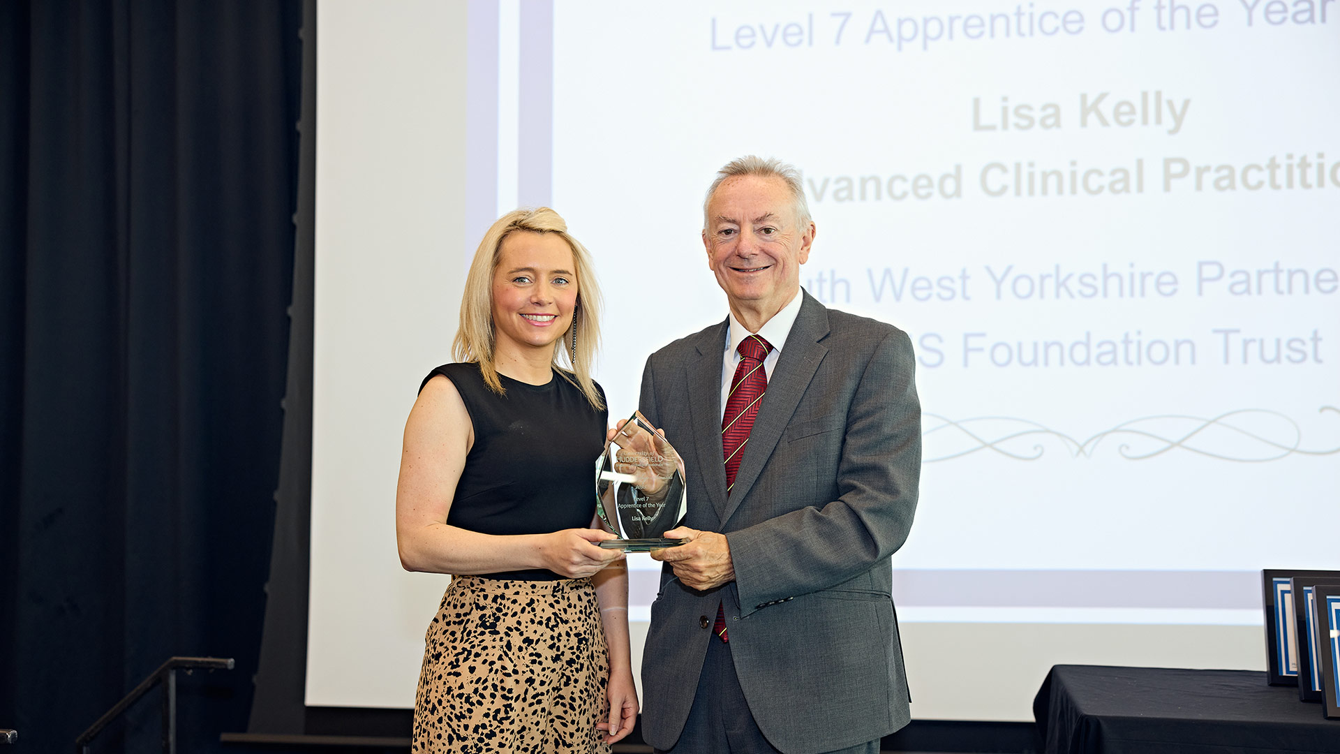 A woman receiving an award on stage
