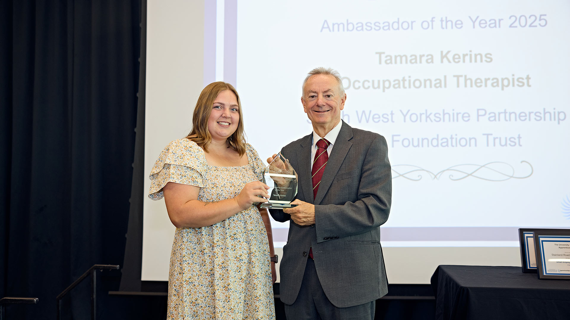 A woman receiving an award on stage