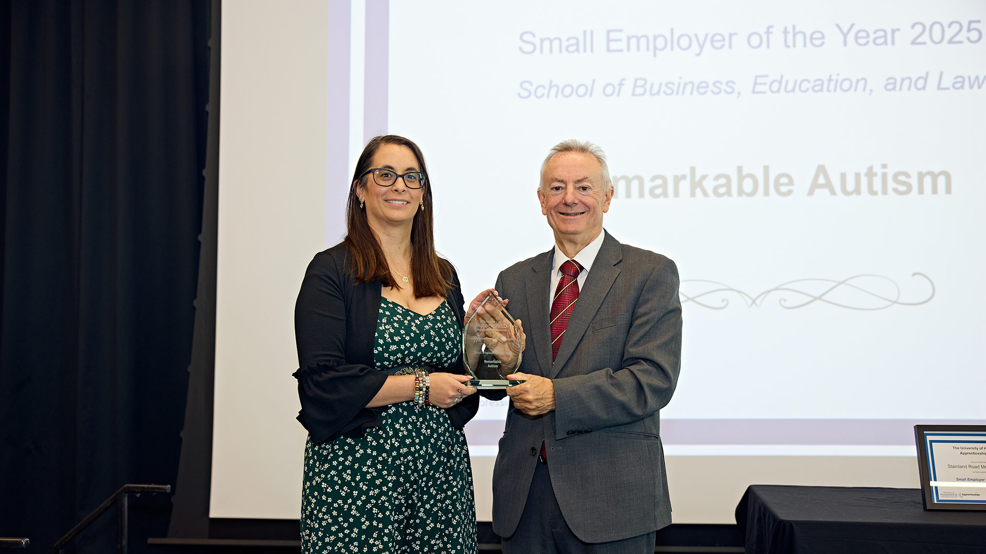 A woman receiving an award on stage