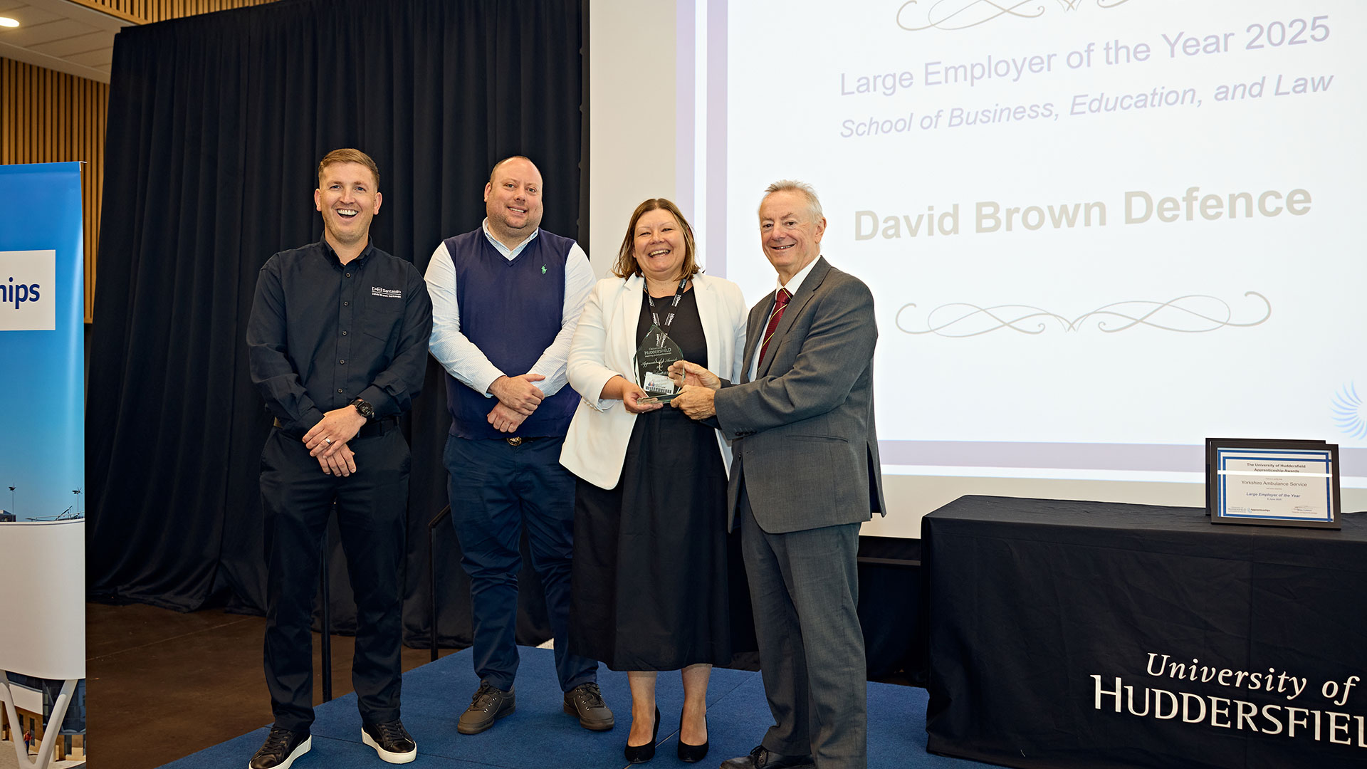 A group of people receiving an award on stage