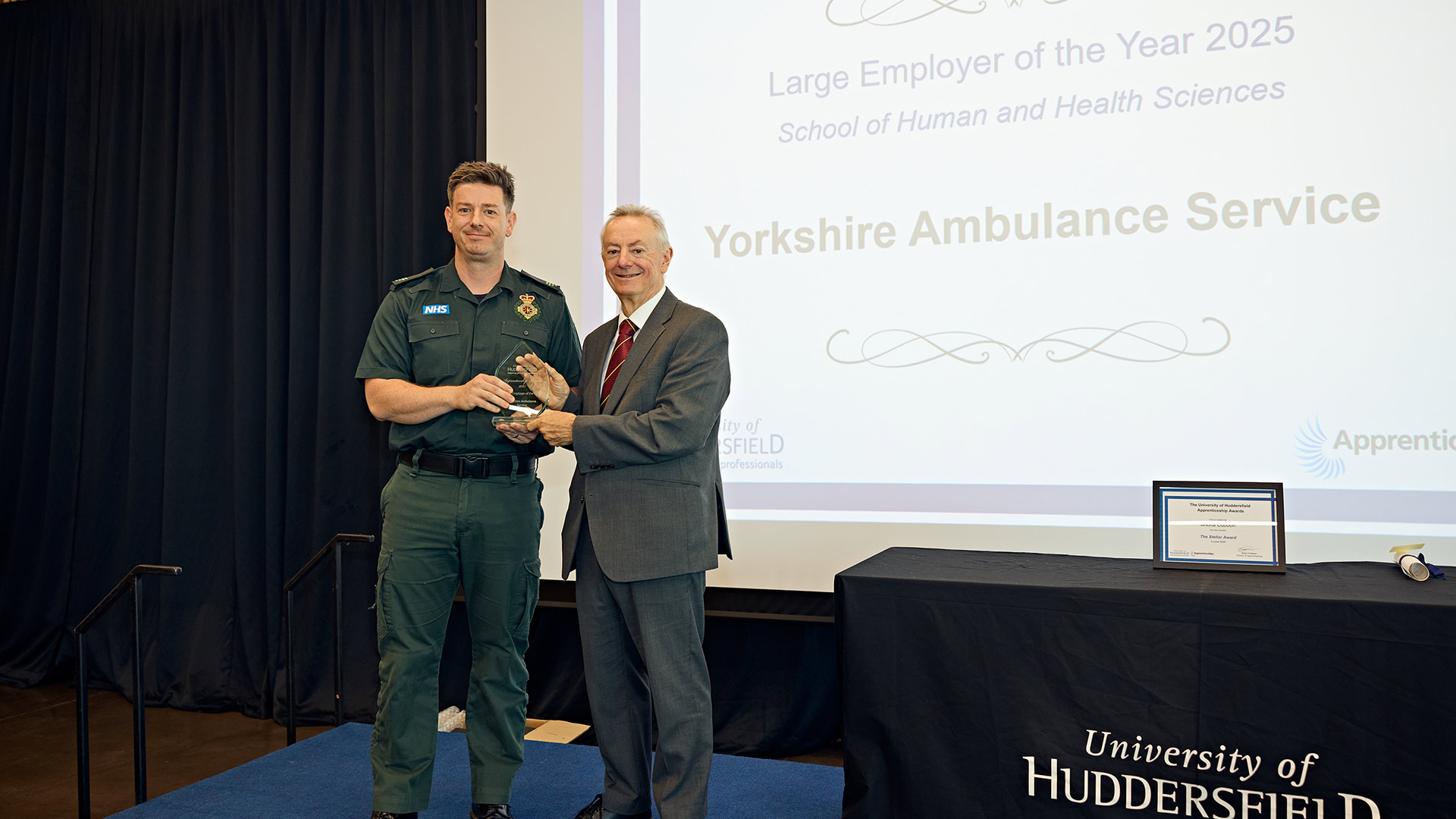 A man receiving an award on stage