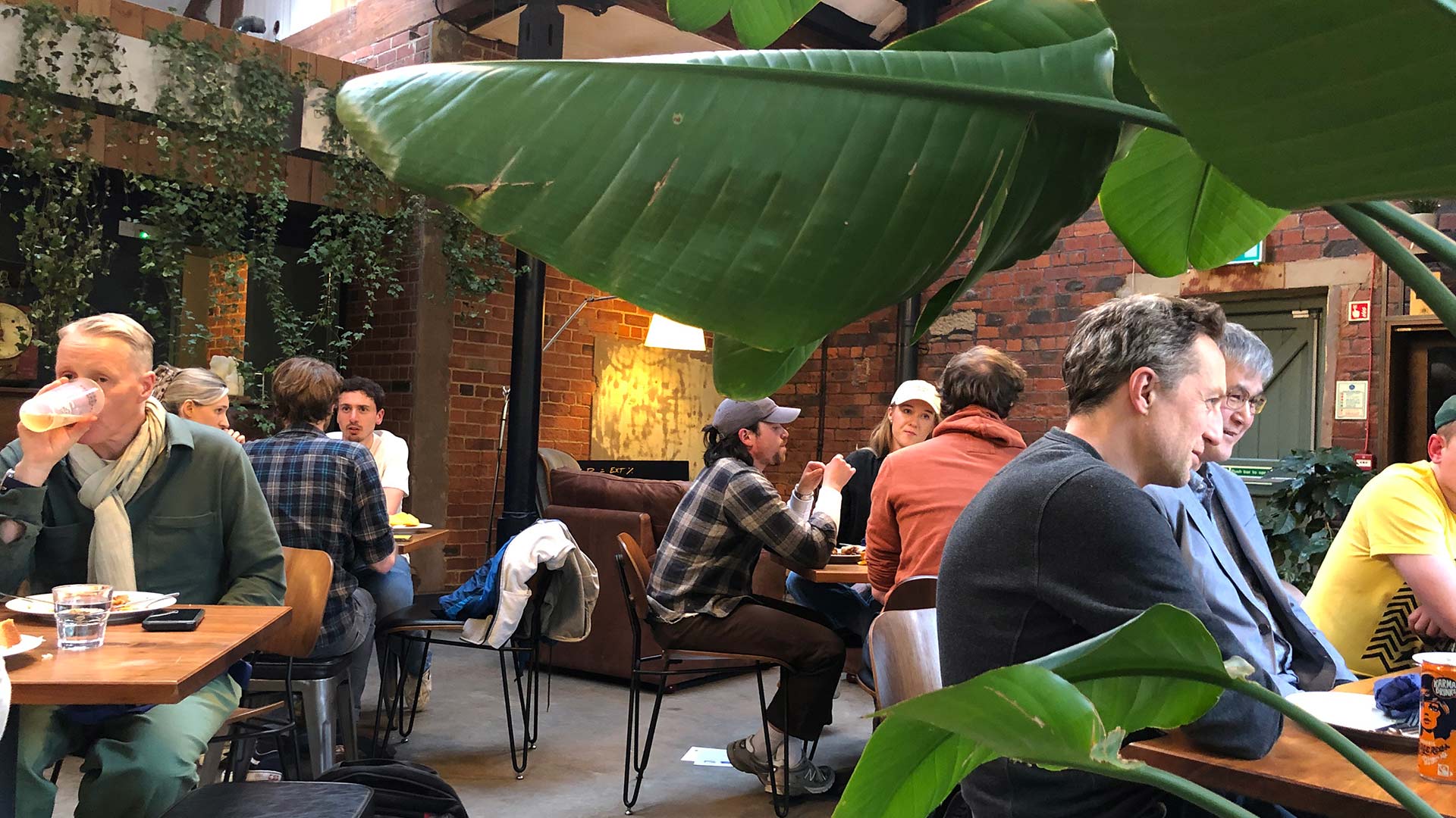 People sitting at small tables during a coffee tasting event