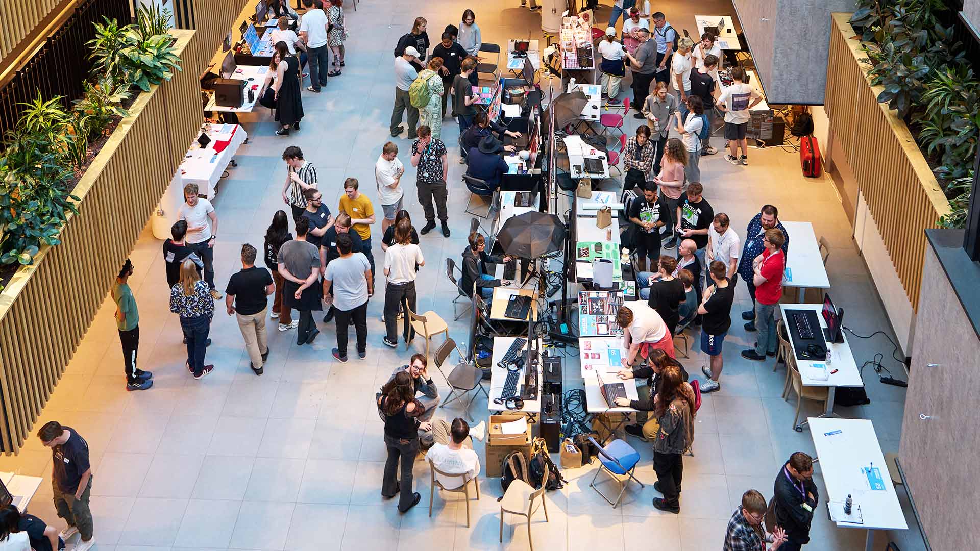 A group of people milling around at a conference