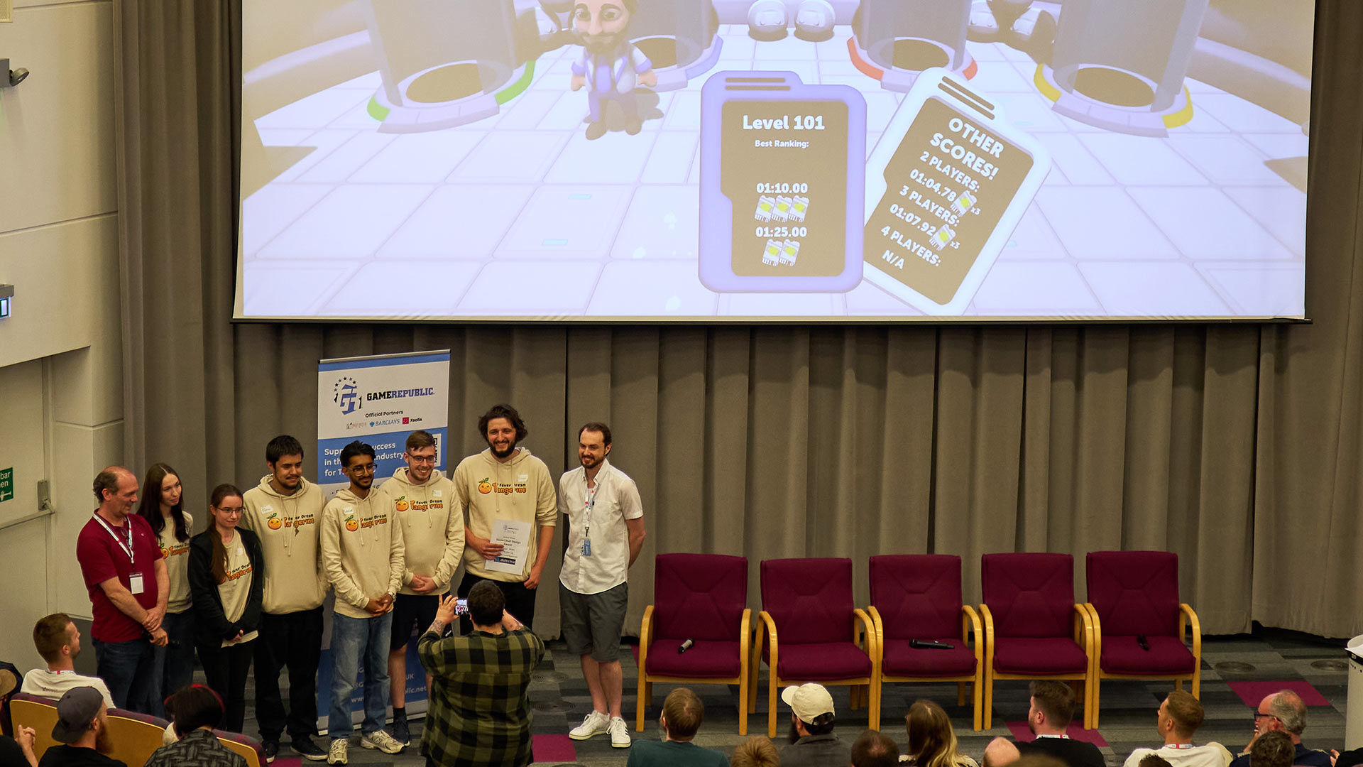 A group of students on stage picking up an award