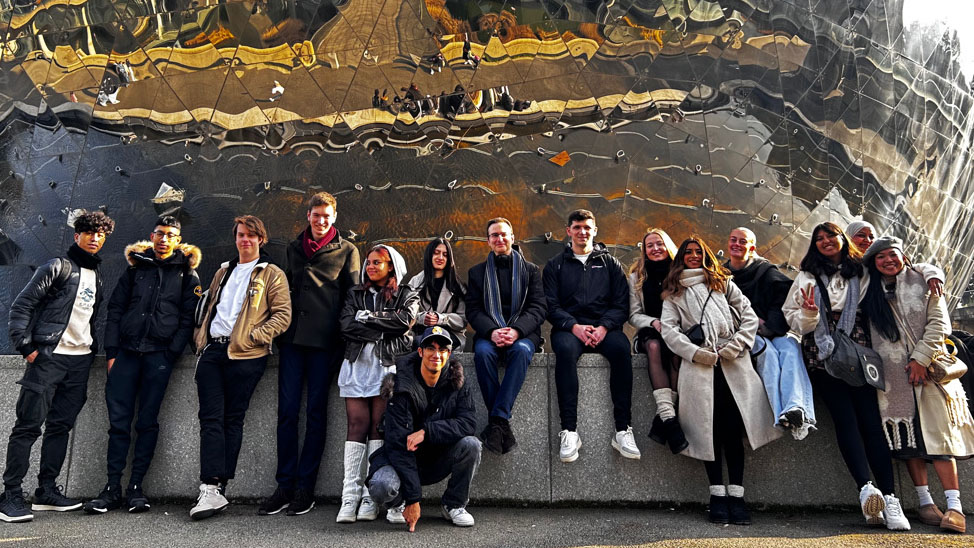 A group of students standing in front of an unusual building in Paris