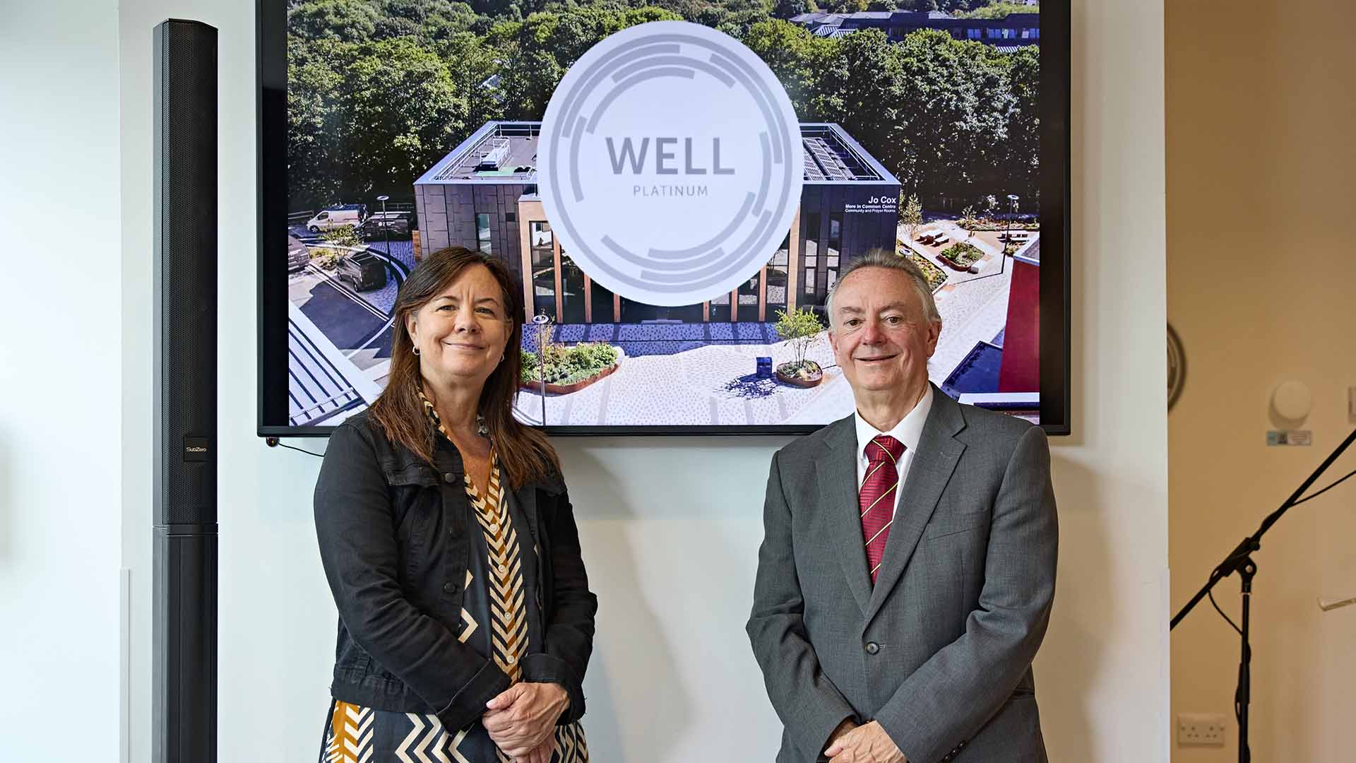 Bob Cryan and Ann Marie Aguilar with the WELL Platinum plaque