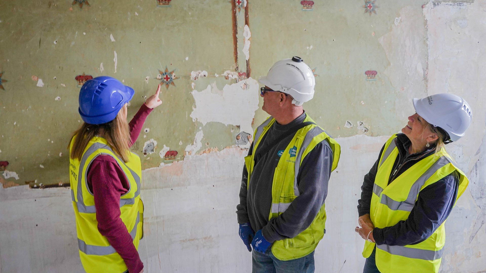 Becky Bowd, Andy Desay and Louise Drover look at Ramsden Building wallpaper