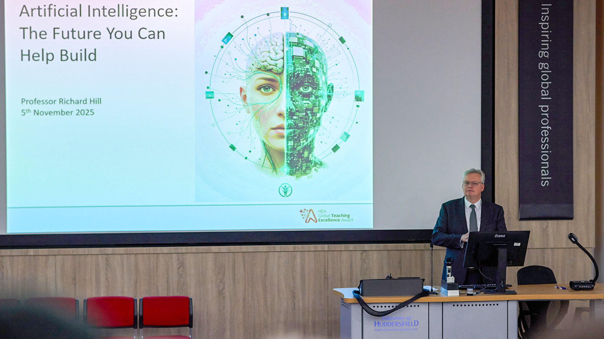 An academic presenting on stage at a conference