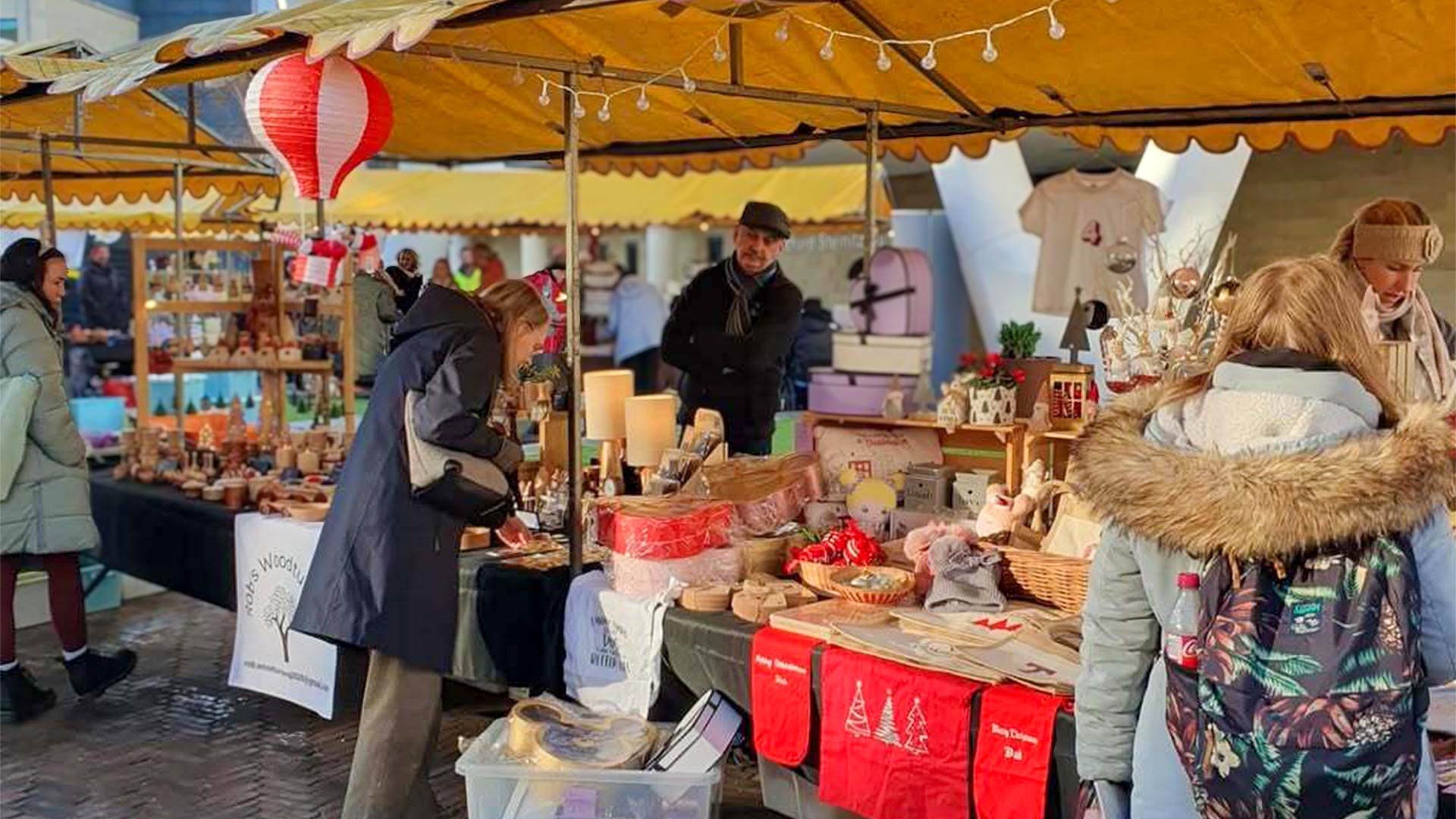 People browsing at a Christmas market stall