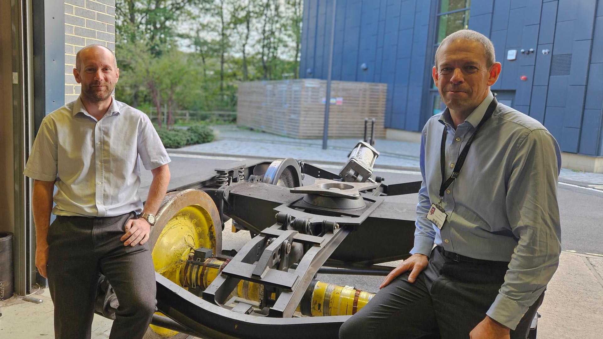 two men with rail testing equipment