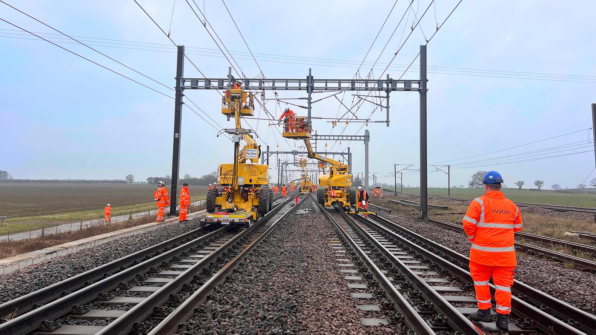 workers upgrading the overhead lines on a railway