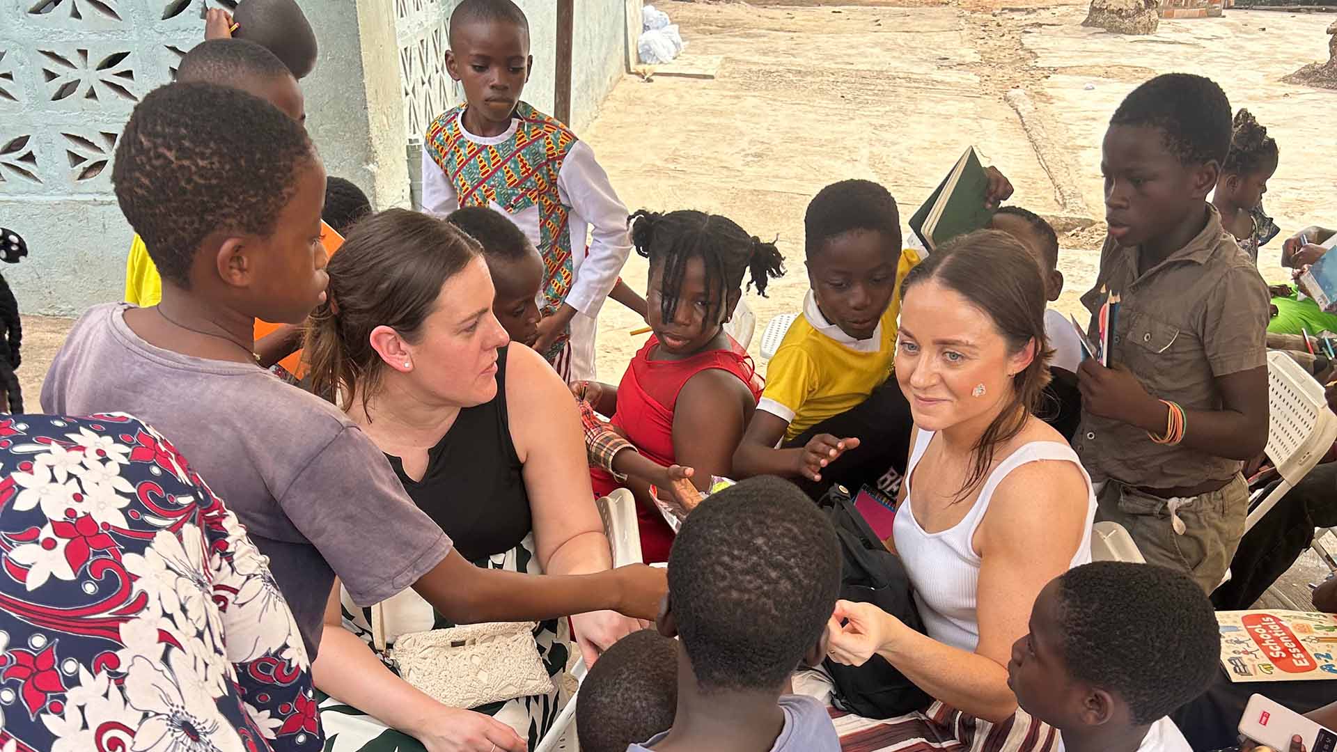 Jen McVay and Sally Stables with children in an outdoor situation at the King Jesus Charity Home