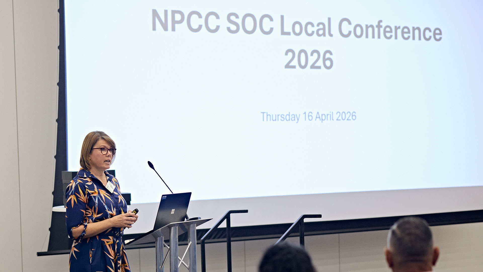 Wendy Gunney talks from a lectern in front of a screen