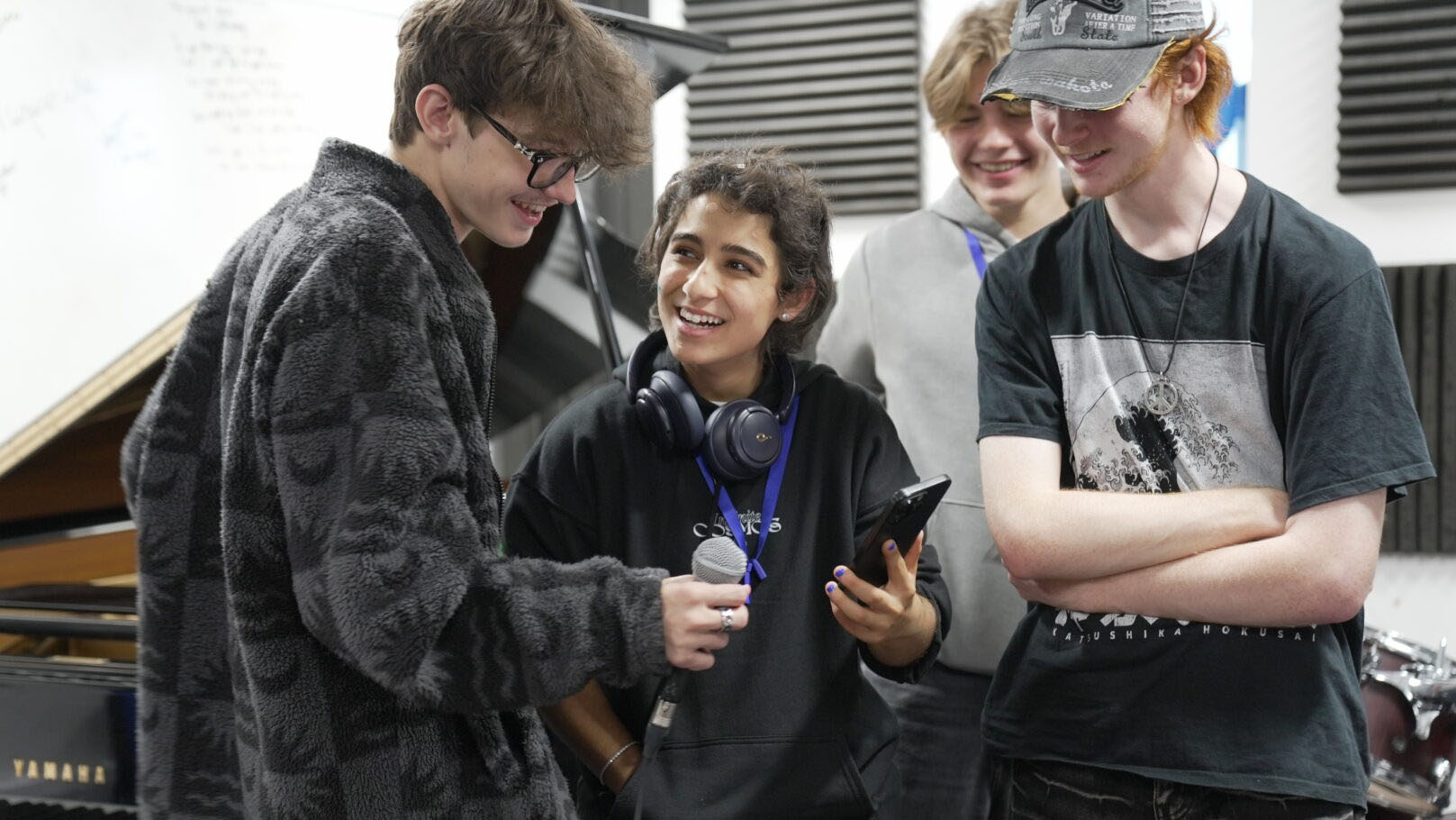 Young musicians look at mobile devices