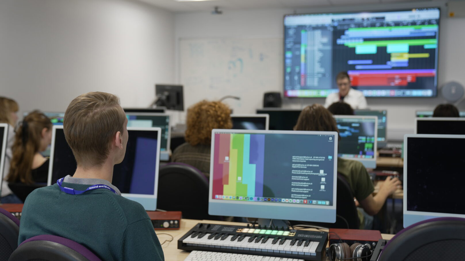 Young people sat at computer screens