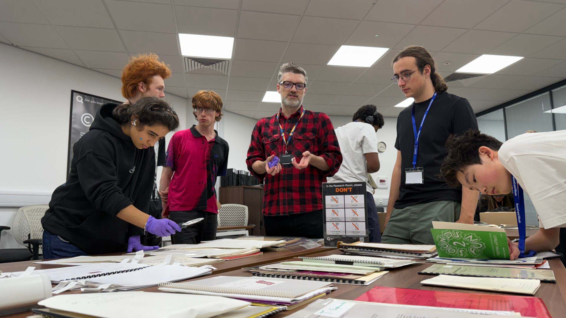 Students look at archive material in an archive room