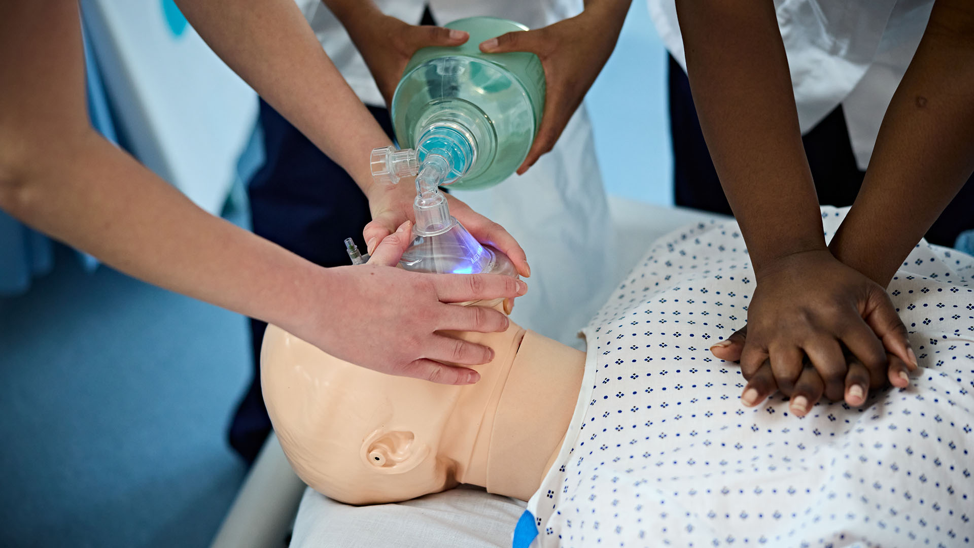 Student nurses work on a mannequin