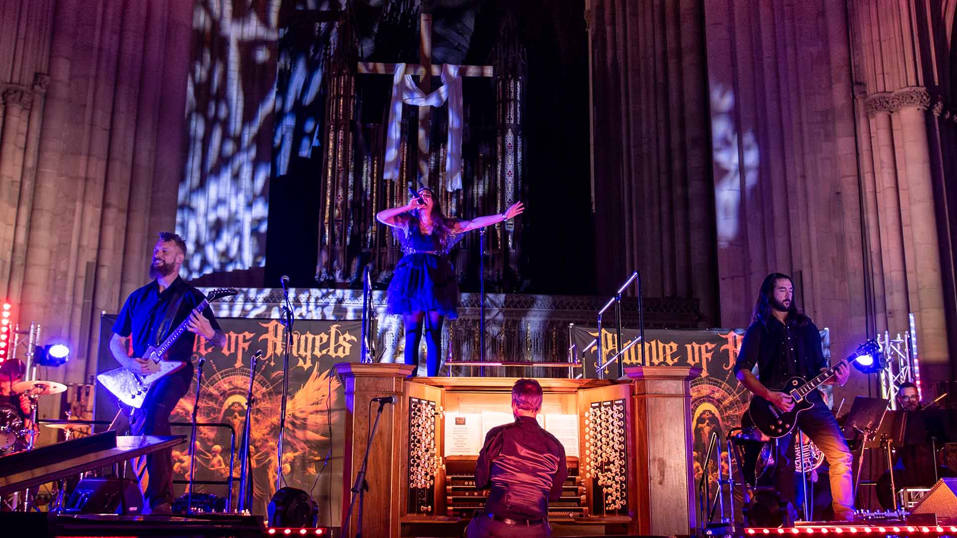 The band Plague of Angels playing inside York Minster in front of a large pipe organ.