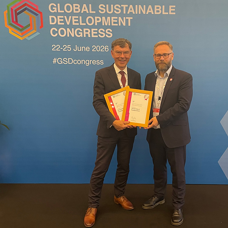 Tim Thornton holds two award certificates