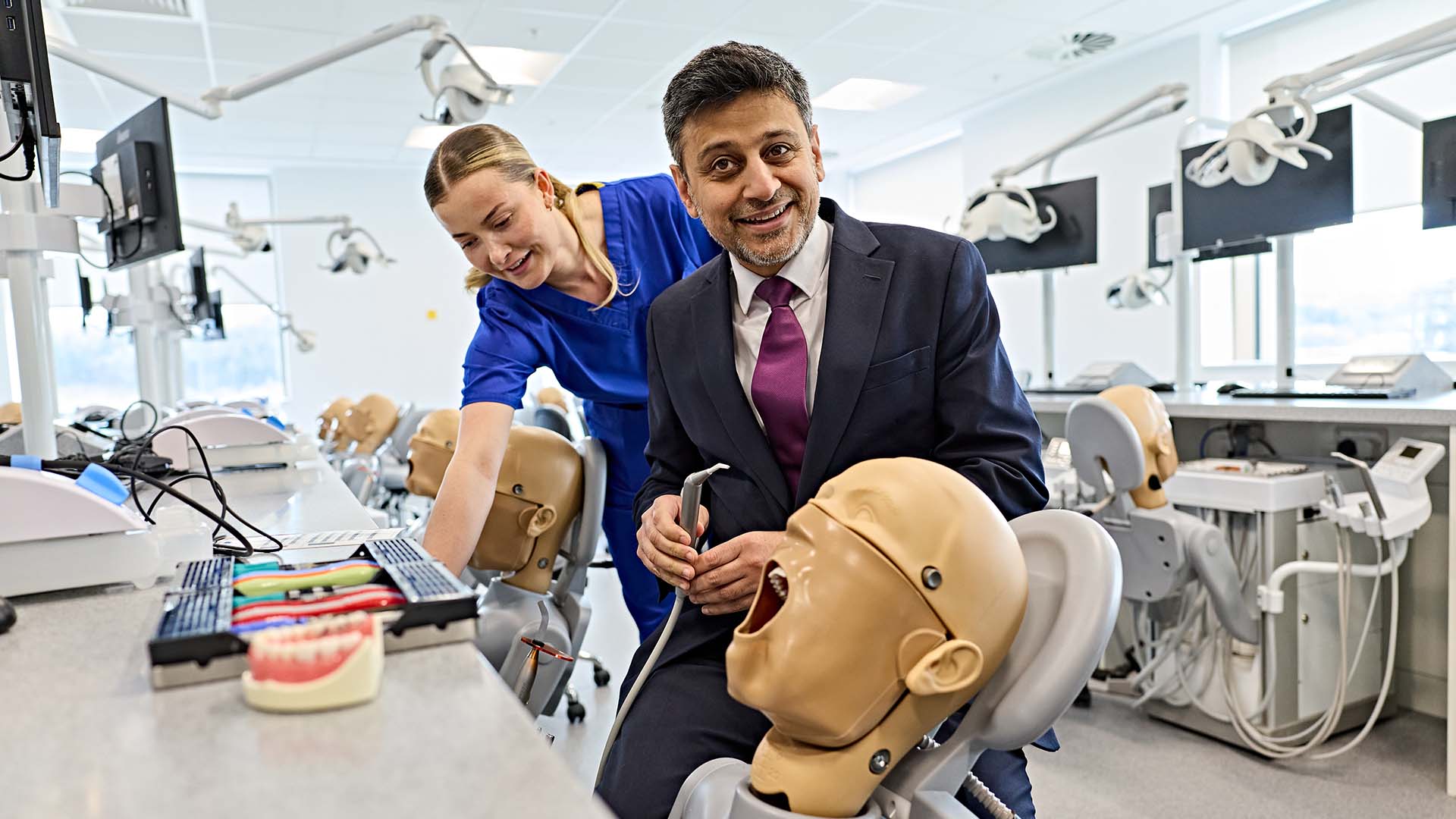 Dr Zubir Ahmed with a mannequin simulating dental treatment