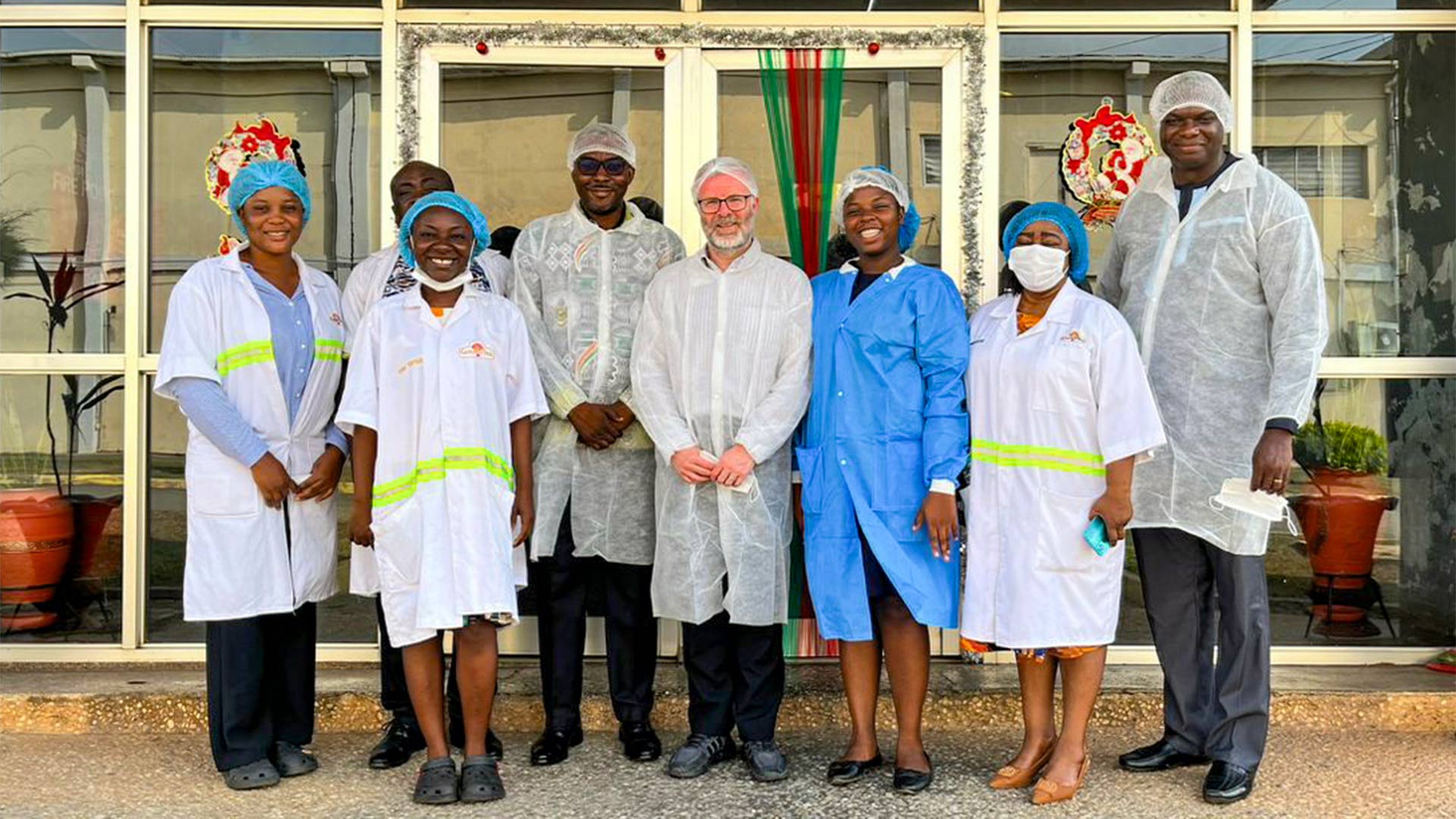 A group of people wearing gear at a manufacturing plant in Ghana