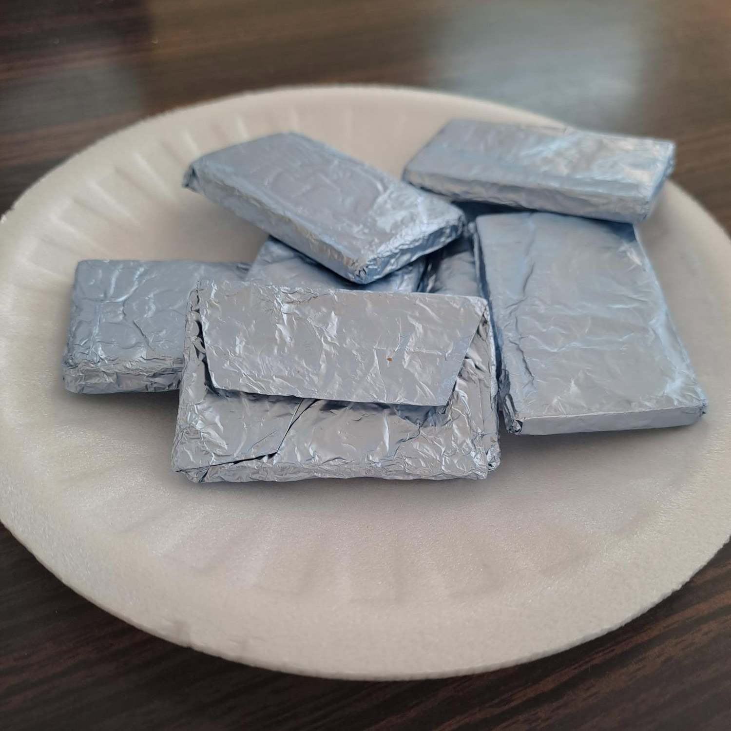 Foil wrapped chocolate samples on a plate