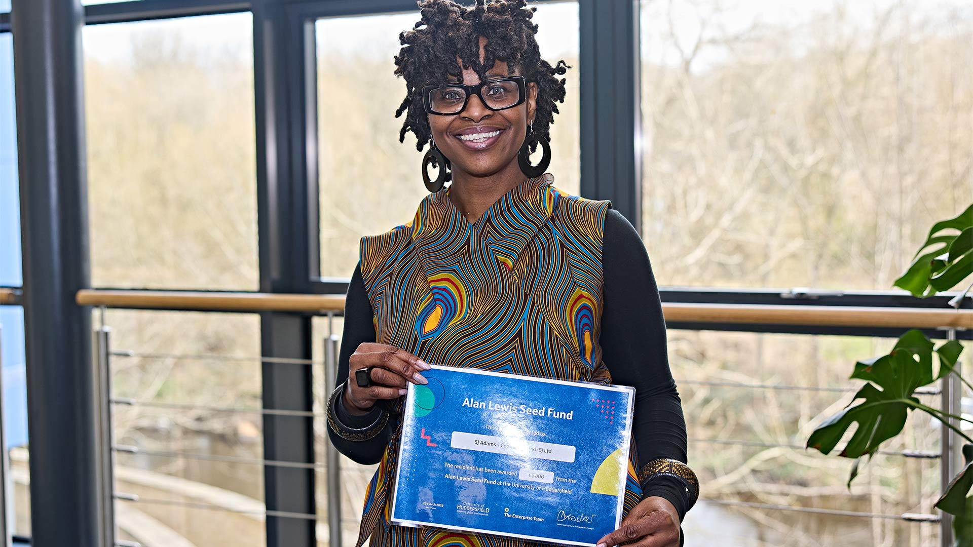 A woman holding a certificate