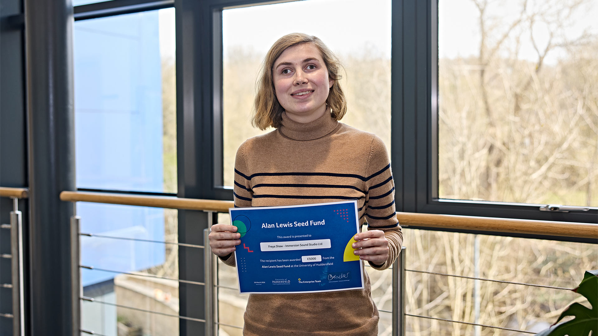 A woman holding a certificate