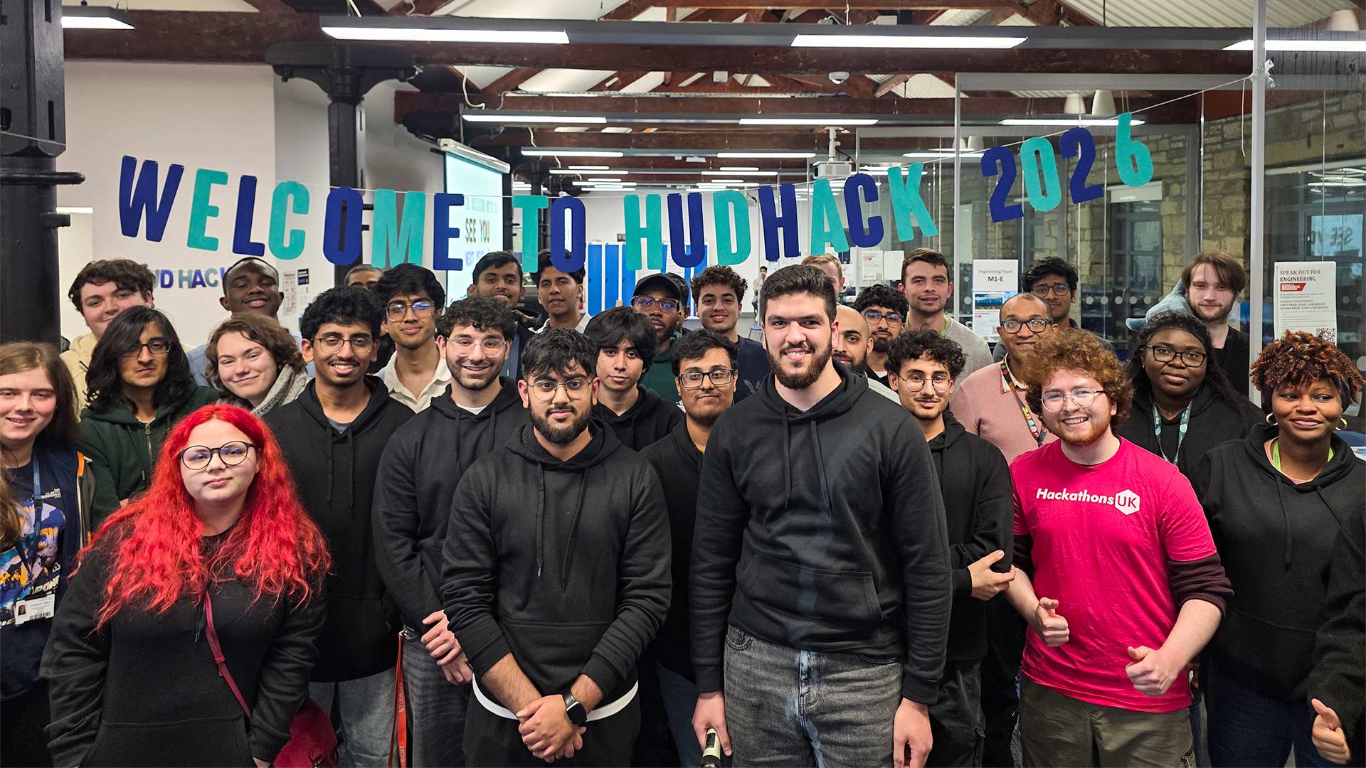 A group of students gathered under a banner