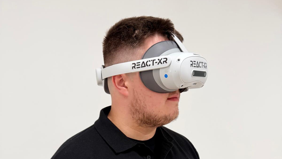 A virtual reality headset worn by a male member of staff