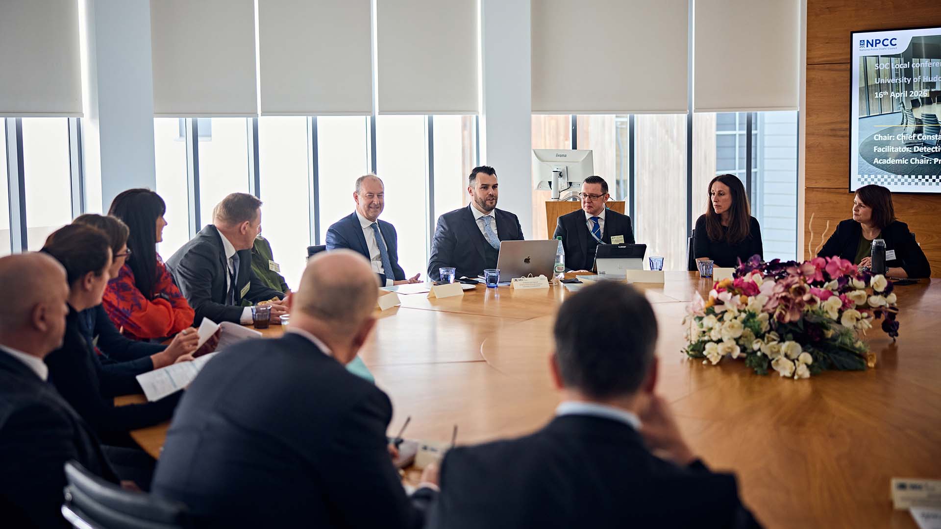 Delegates sat around a table at a conference at the University of Huddersfield