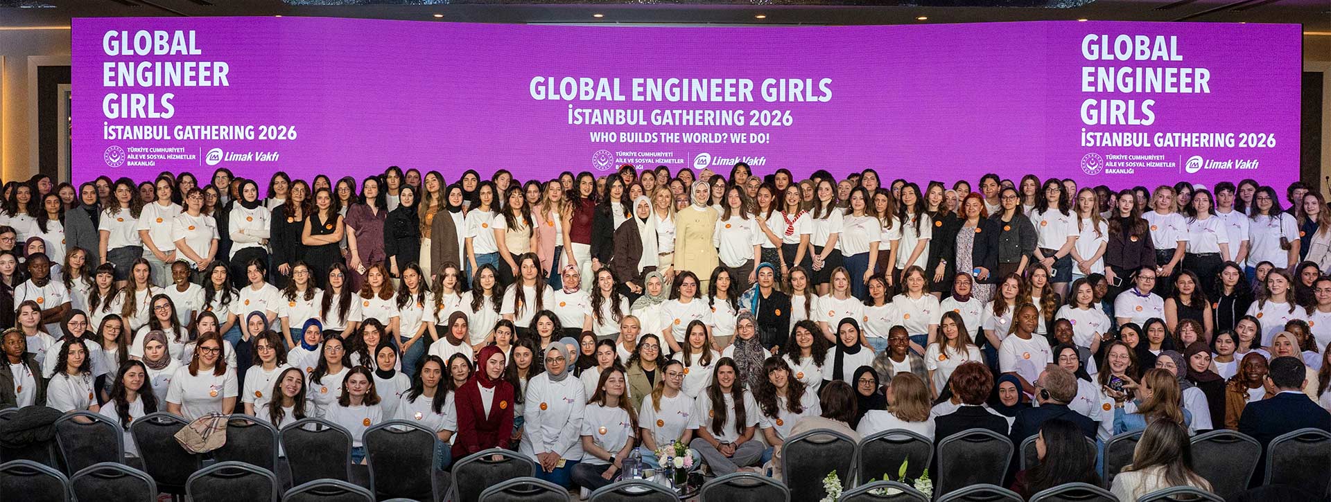 Large group gathered on stage at Global Engineer Girls Istanbul Gathering 2026, with event branding displayed on purple backdrop behind participants.