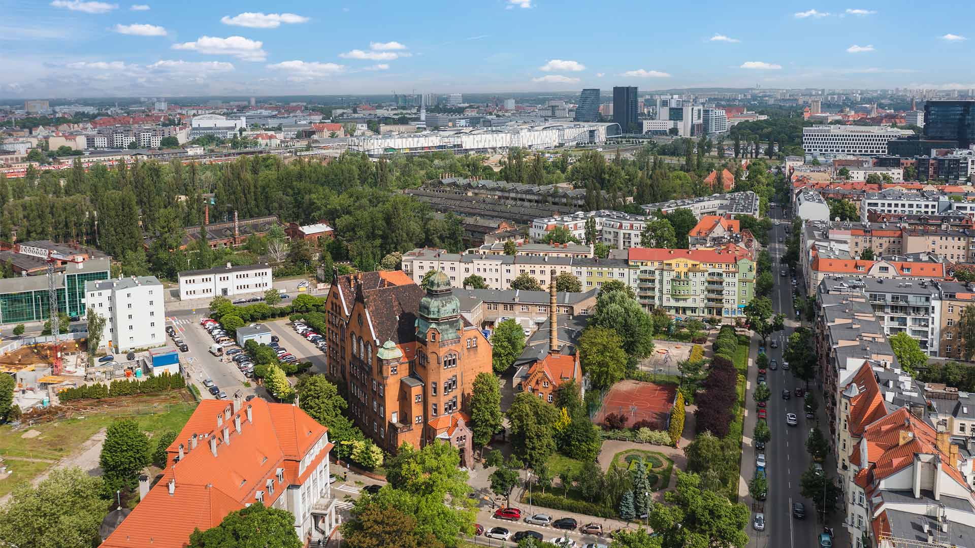 A panoramic aerial view of a district in Poznan, Poland., with a Poznan University of Technology building in the foreground.