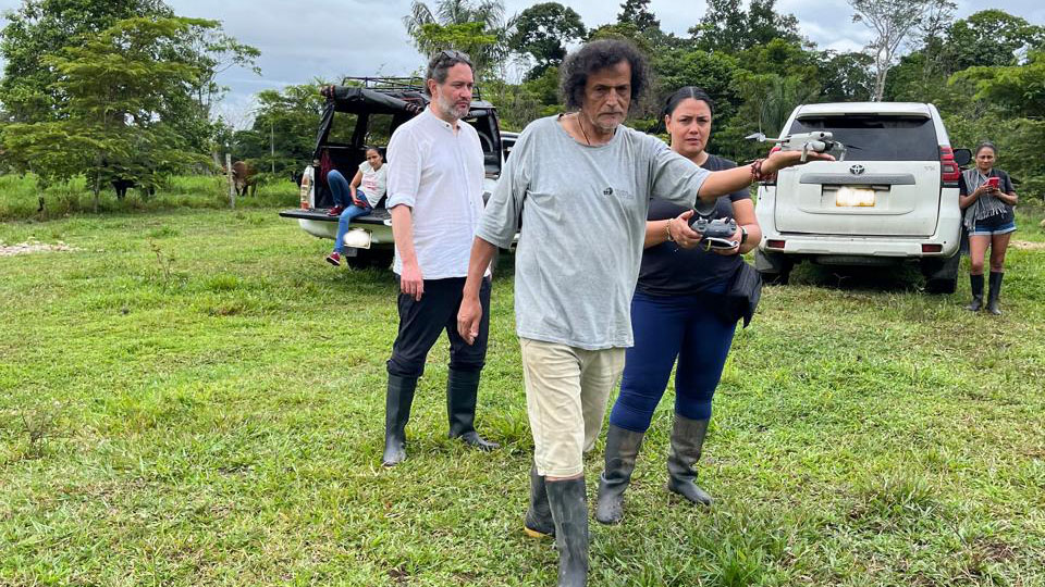 Researchers stand outside a 4-wheel drive in Colombia's countryside