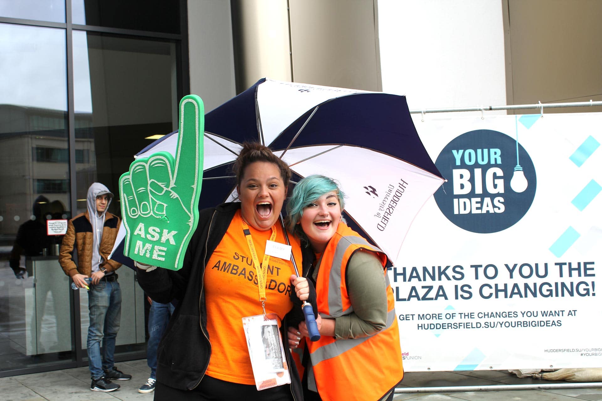 Student Ambassadors under an umbrella on an AVD