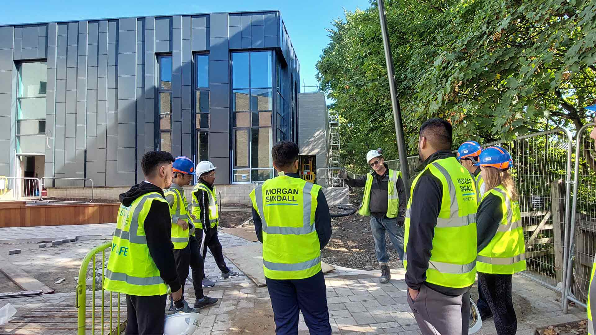 Students working with construction team on projects on campus