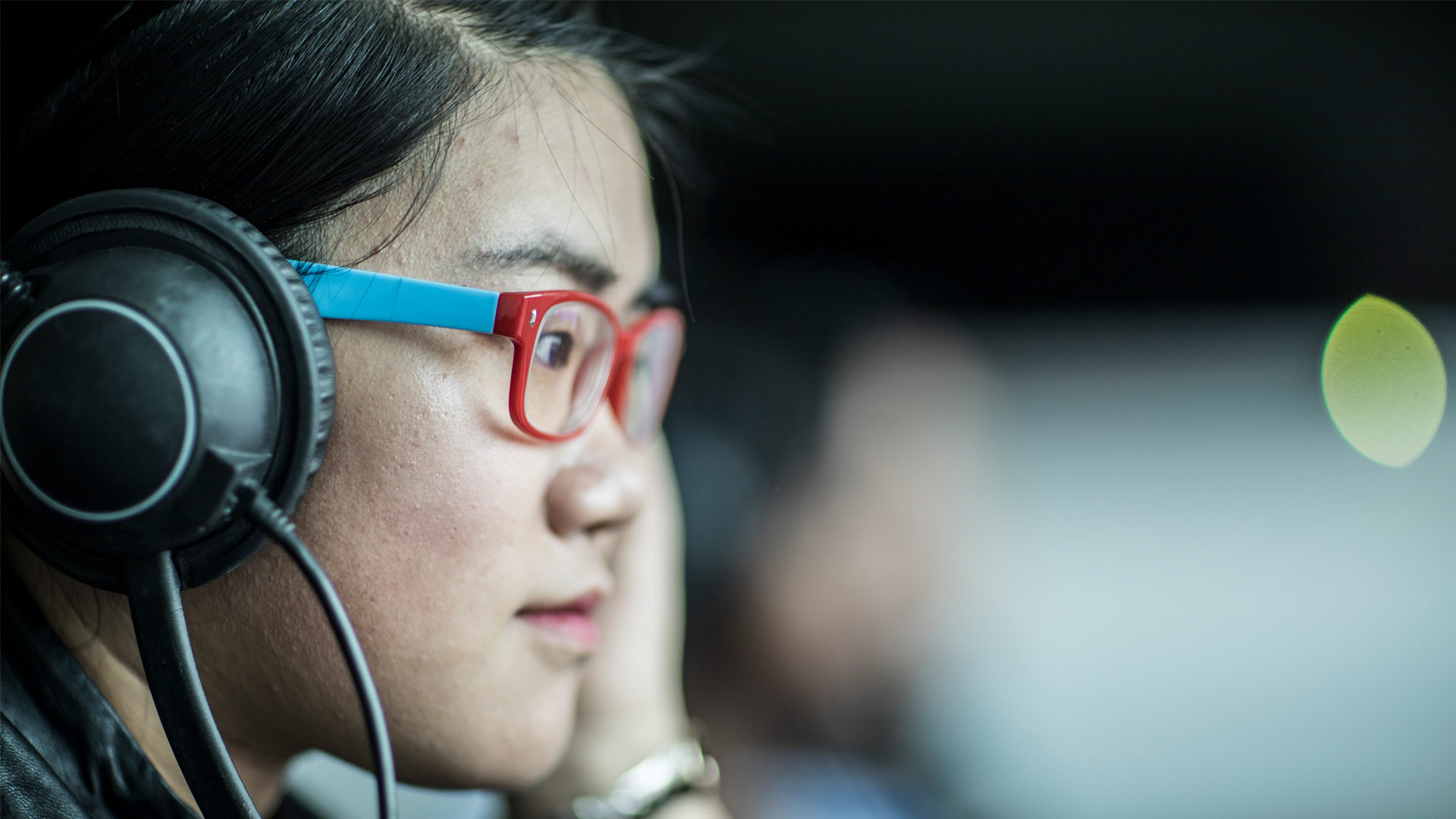 Student working on computer with headphones