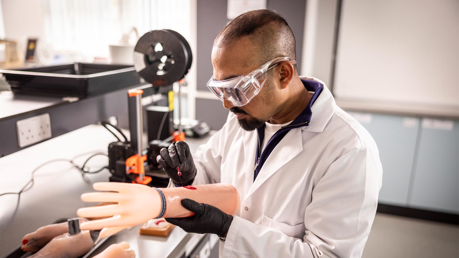 Student working with Pharmacology equipment and analysing medical anomalies on simulated arm