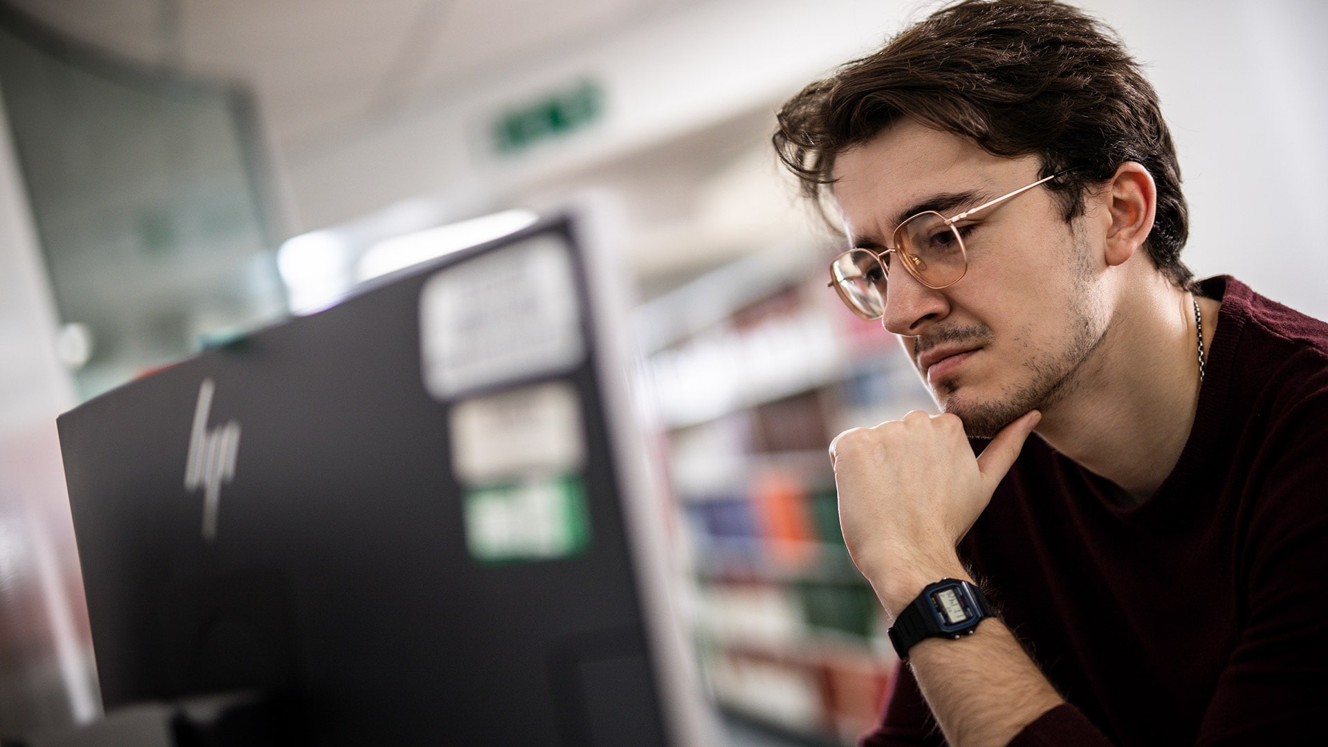 A postgraduate student looking at a computer screen.