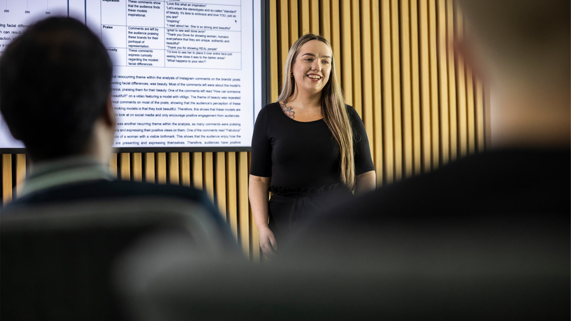 Student presenting information on screen to other students in seminar