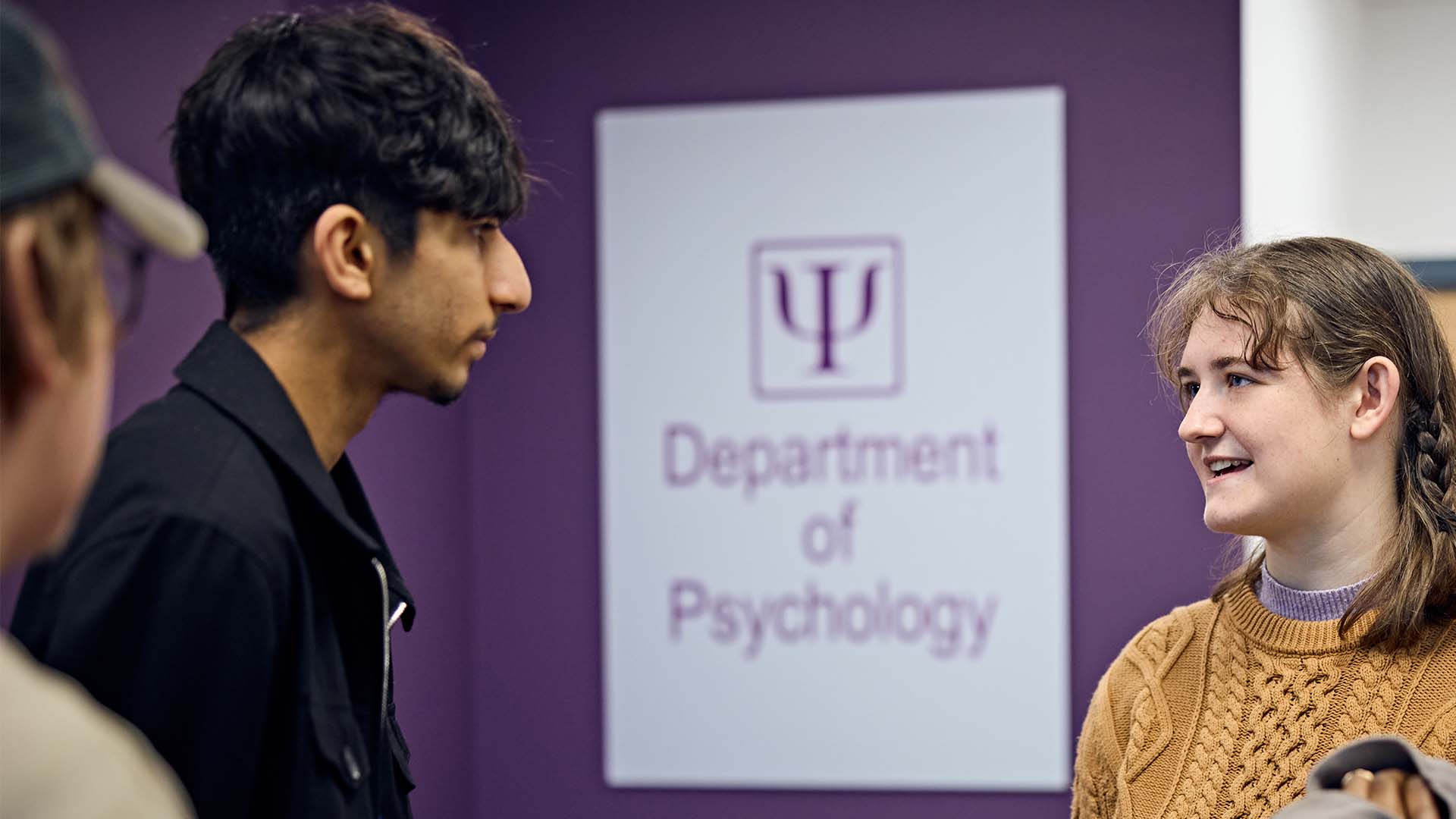 Students stood in front of Department of Psychology sign