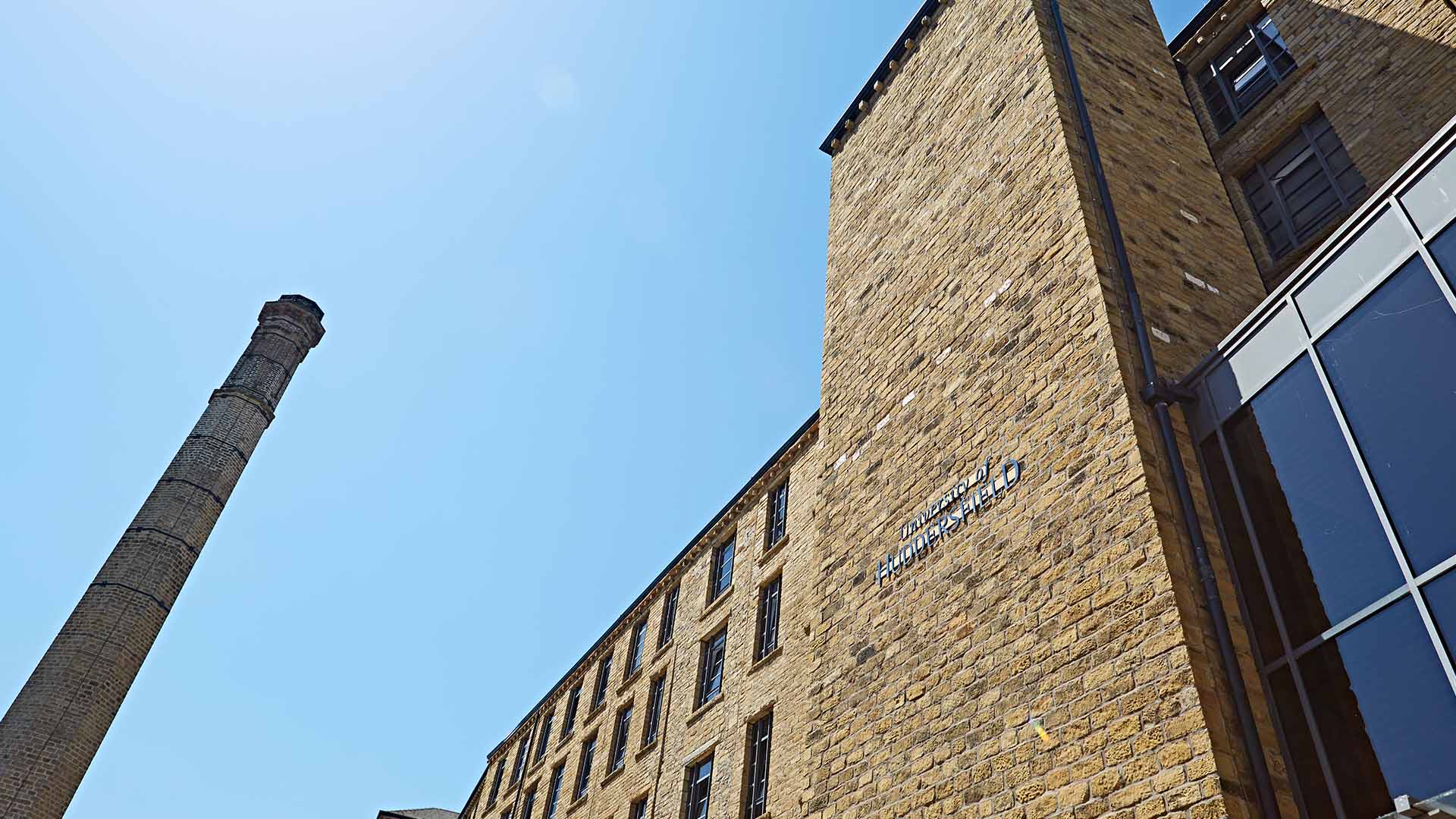 Image of a brick building with a glass wall