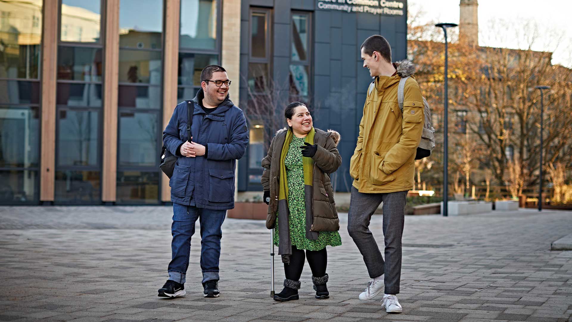 Three students walk by the Jo Cox More in Common Centre