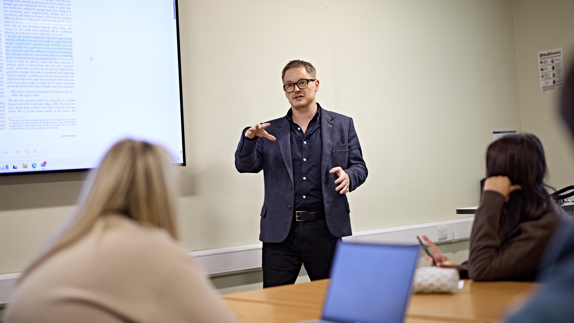 Session leader running through slides presentation and discussing with students in tutorial