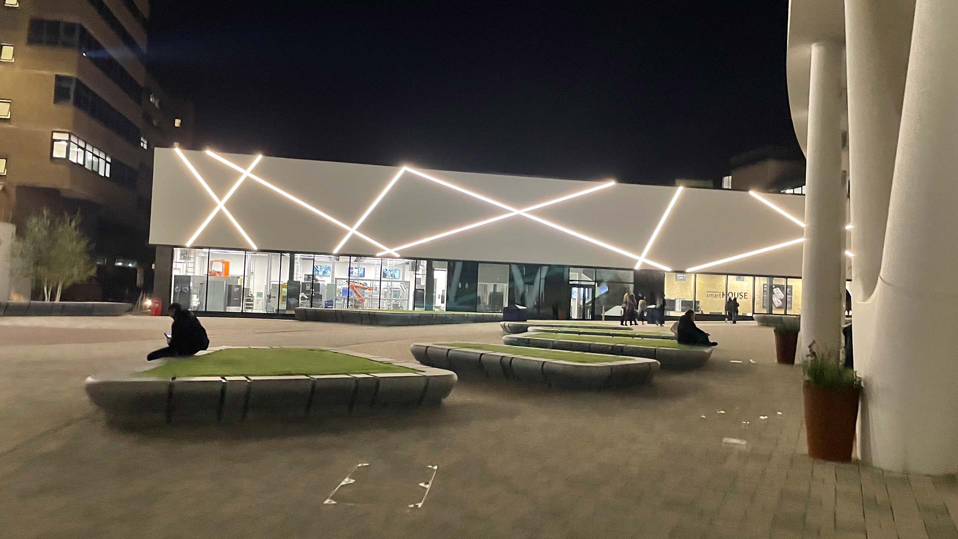 The University of Huddersfield main plaza at night, with the Laura Annie Wilson engineering building lit up.