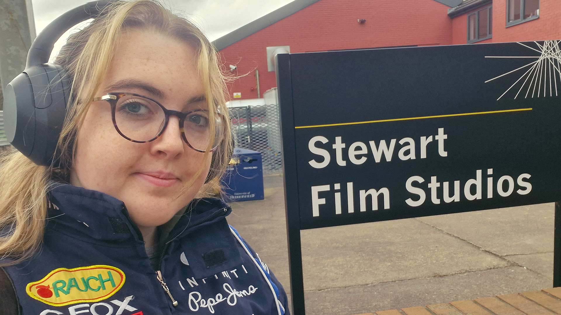 Eloise stood next to the Stewart Film Studios sign.