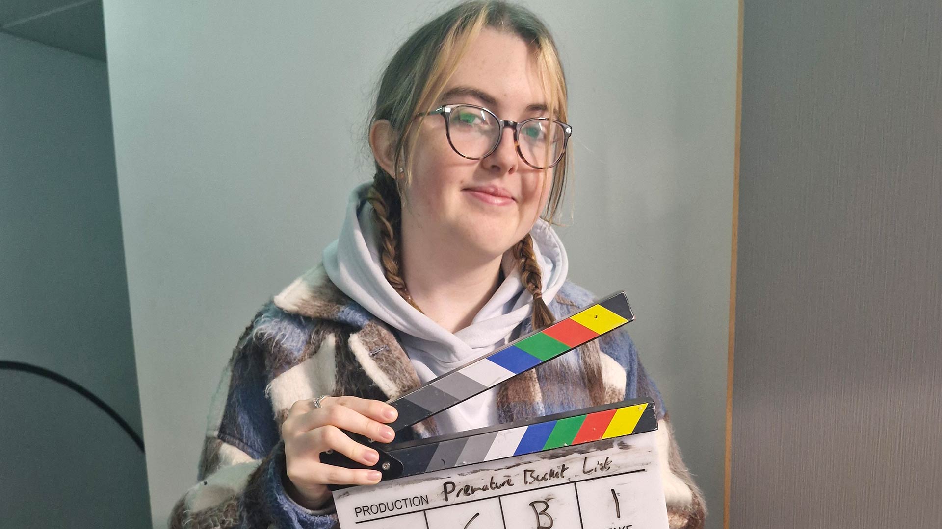Eloise holding a directors clapboard