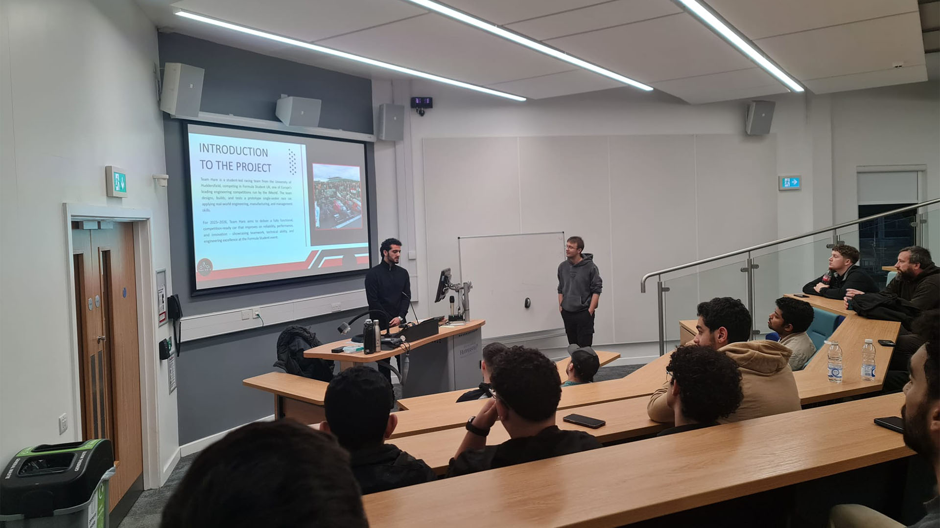 Saad Zahir delivering a presentation to fellow students in a lecture theatre.