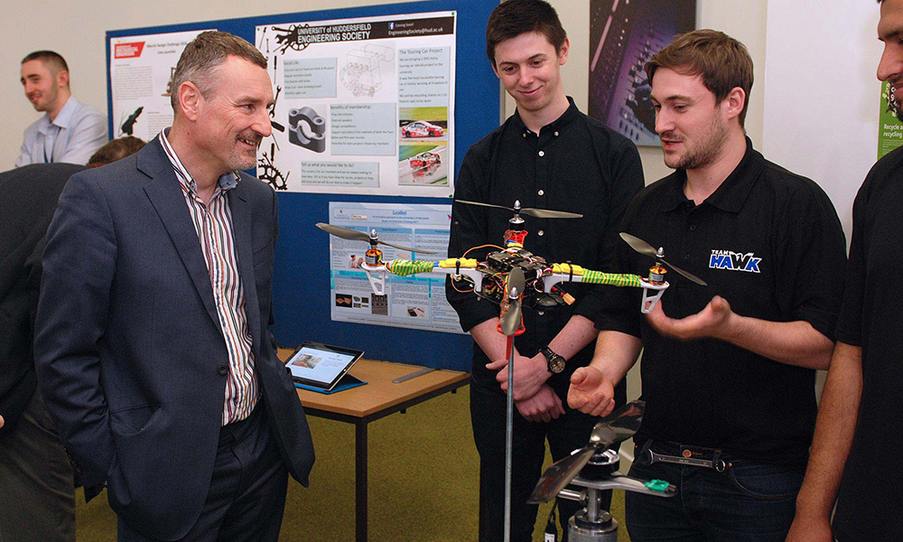Students from Team HAWK show the President of the IMechE their prototype drone for the Unmanned Aircraft Systems Challenge.
