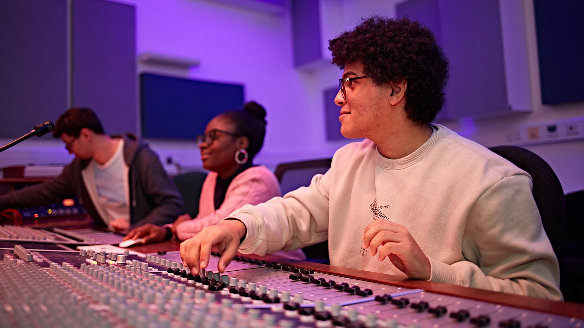 Three students in the Music Technology mixing studio